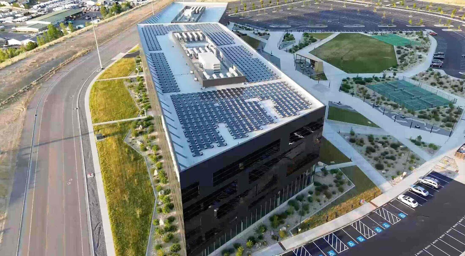Aerial view of a client facility with extensive rooftop solar, supported by Torus hybrid flywheel-battery storage for grid stability and peak shaving.